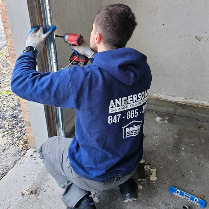 Garage Door Repair in Lake Forest IL A garage door technician installing track for a brand new garage door near Lake Forest, IL