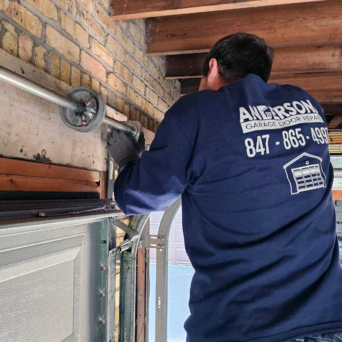 Garage Door Repair in Lake Forest IL Garage door repair technician fixing the spring near Lake Forest IL